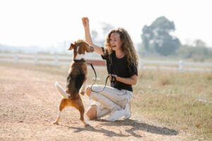 dog owner training her happy dog
